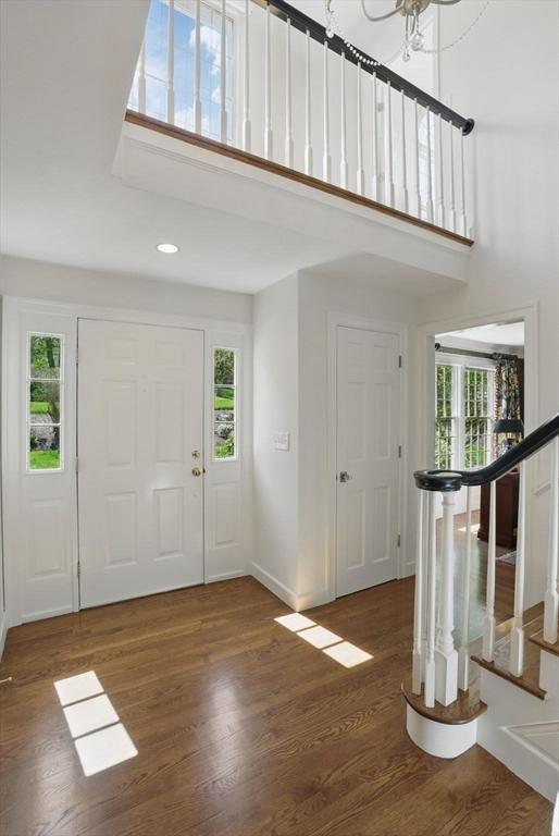 11 Edge Hill Rd, Hopkinton, MA 01748 - foyer entrance with healthy amount of natural light, a towering ceiling, wood finished floors, baseboards, and recessed lighting