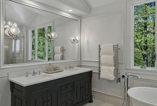 11 Edge Hill Rd, Hopkinton, MA 01748 - bathroom with radiator heating unit, double vanity, a chandelier, and a decorative wall