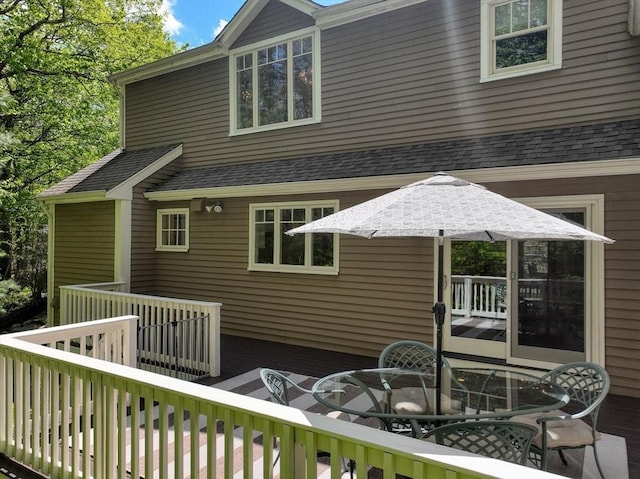 11 Edge Hill Rd, Hopkinton, MA 01748 - back of property with outdoor dining area, a wooden deck, and roof with shingles