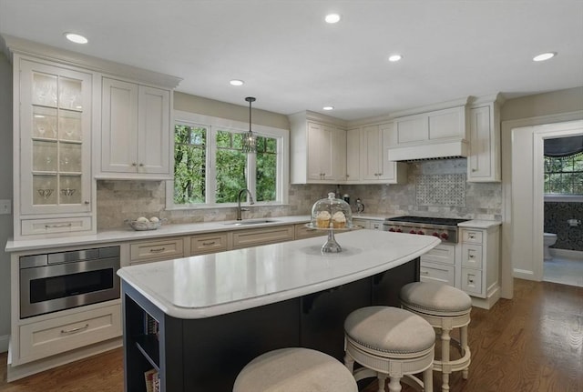 11 Edge Hill Rd, Hopkinton, MA 01748 - kitchen featuring a sink, light countertops, a center island, dark wood-style flooring, and recessed lighting