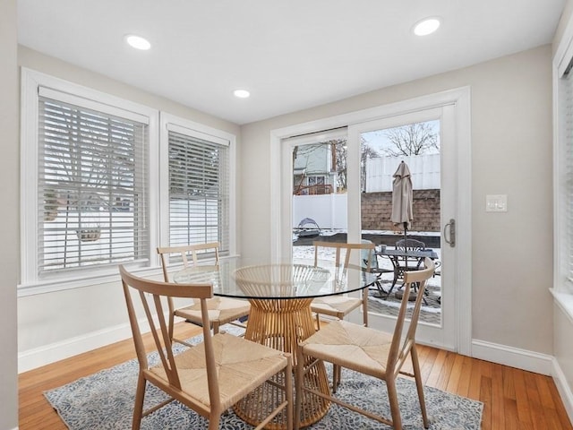 dining space with hardwood / wood-style flooring