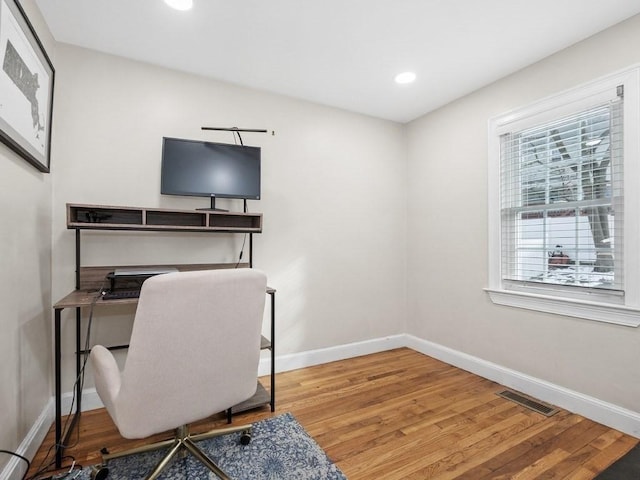 office space with hardwood / wood-style floors