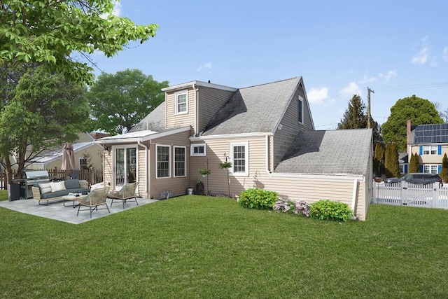 rear view of property featuring an outdoor living space, a patio, and a yard