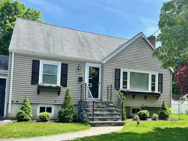 new england style home with a front yard