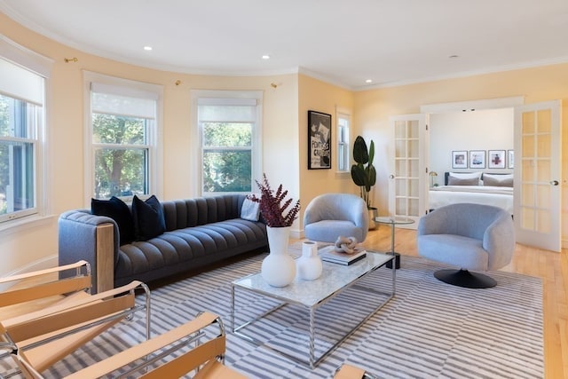 living room featuring crown molding, hardwood / wood-style floors, and french doors