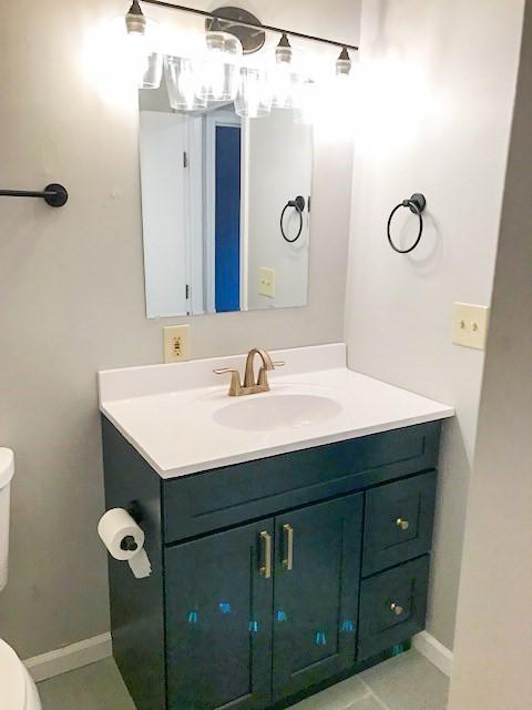10 Longworth Ave Unit 12, Brockton, MA 02301 - bathroom with toilet, vanity, tile patterned flooring, and baseboards