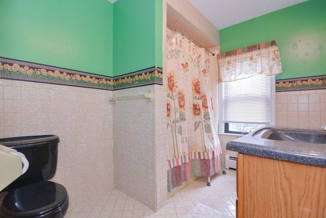 886 Canterbury St, Boston, MA 02131 - full bathroom featuring tile walls, toilet, a baseboard radiator, vanity, and wainscoting
