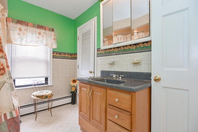 886 Canterbury St, Boston, MA 02131 - kitchen featuring a sink, a baseboard heating unit, tile walls, dark countertops, and light floors