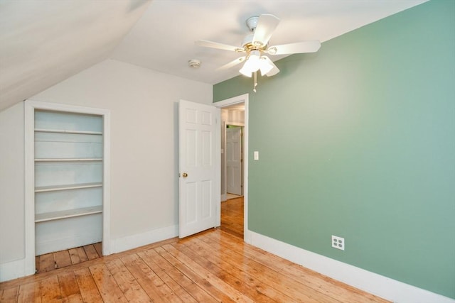 886 Canterbury St, Boston, MA 02131 - unfurnished bedroom featuring wood-type flooring, vaulted ceiling, a ceiling fan, and baseboards