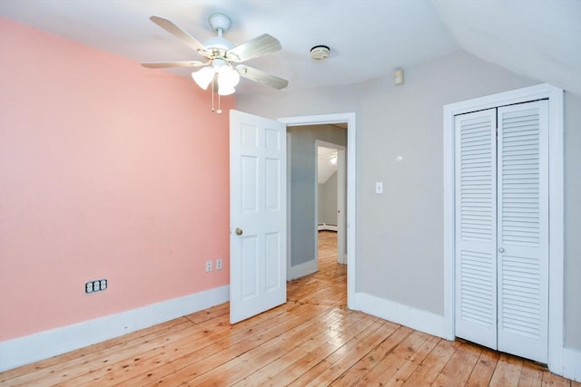 886 Canterbury St, Boston, MA 02131 - unfurnished bedroom featuring light wood-type flooring, baseboards, lofted ceiling, a closet, and a baseboard radiator