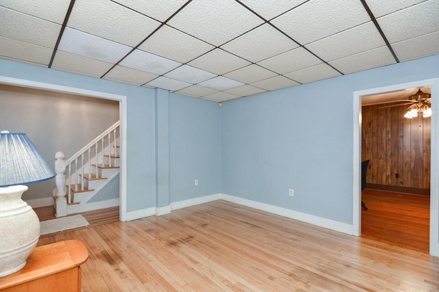886 Canterbury St, Boston, MA 02131 - unfurnished living room featuring hardwood / wood-style flooring, stairway, baseboards, and a drop ceiling
