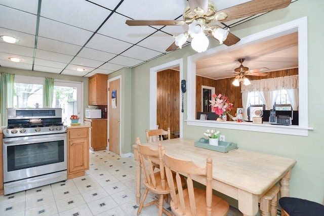 886 Canterbury St, Boston, MA 02131 - kitchen featuring stainless steel range with gas stovetop, a ceiling fan, light countertops, light floors, and white microwave