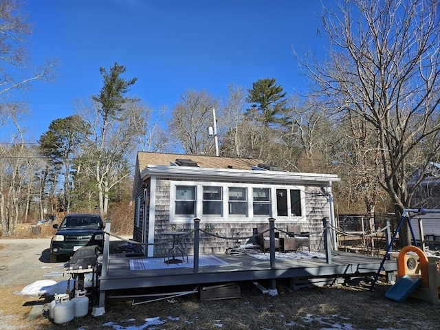 back of house featuring a wooden deck