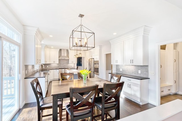 dining area featuring dark wood finished floors, a notable chandelier, and recessed lighting