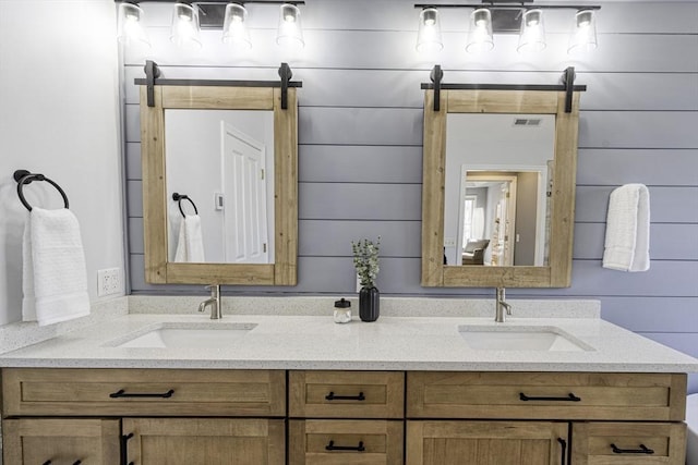 bathroom featuring a sink, visible vents, and double vanity