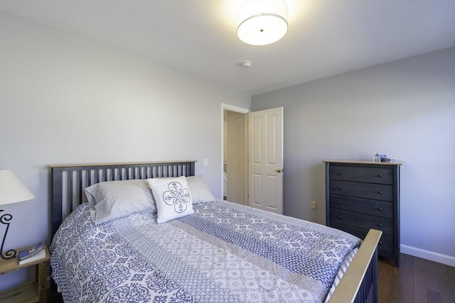 bedroom with baseboards and dark wood-style floors