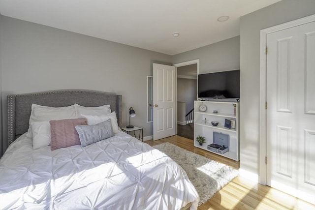 bedroom with baseboards and wood finished floors