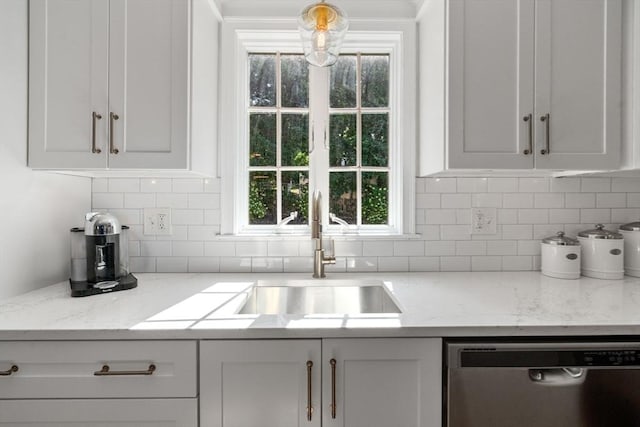 kitchen with white cabinets, stainless steel dishwasher, and a sink