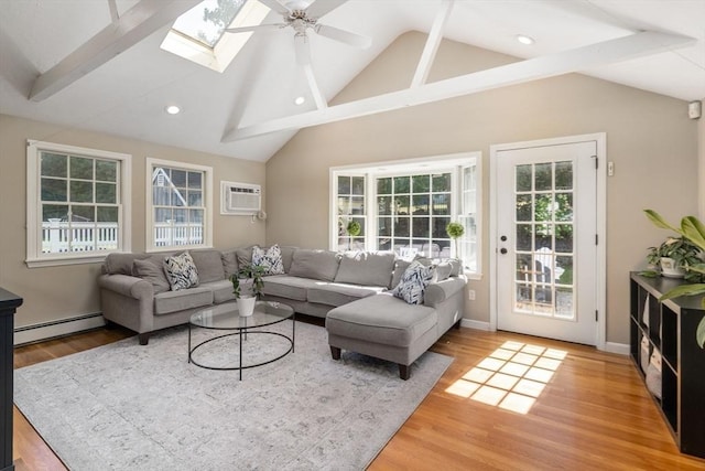 living area with recessed lighting, light wood finished floors, a ceiling fan, a baseboard heating unit, and vaulted ceiling with skylight