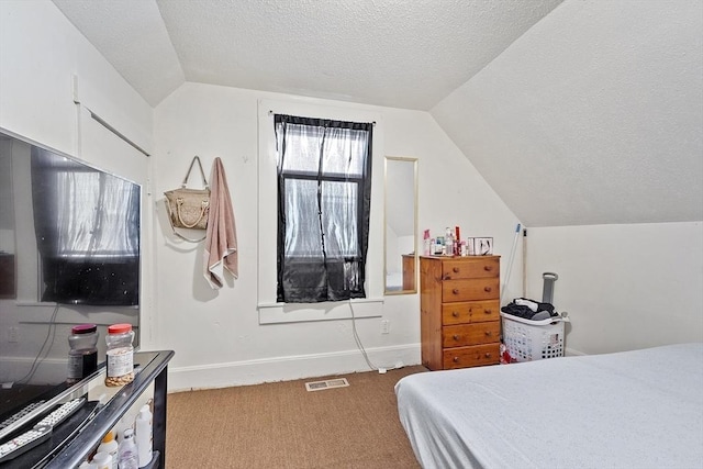 carpeted bedroom featuring vaulted ceiling and a textured ceiling