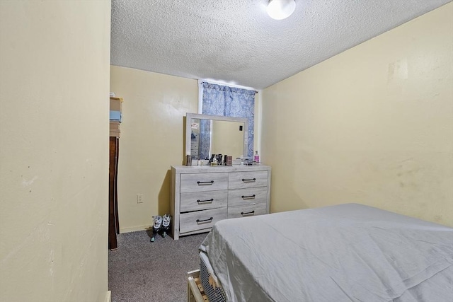 bedroom featuring carpet and a textured ceiling