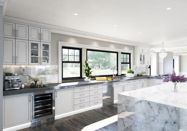 kitchen featuring wine cooler, ornamental molding, glass insert cabinets, and stainless steel dishwasher