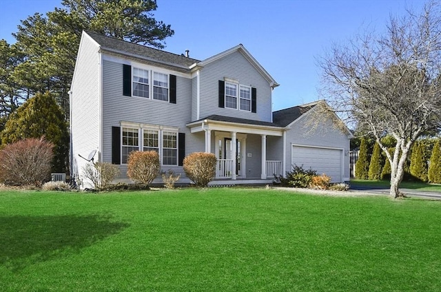 view of front of house with a porch, a garage, and a front lawn