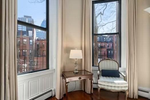 living area with a baseboard heating unit