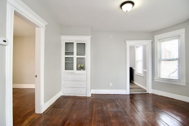 spare room featuring dark hardwood / wood-style flooring