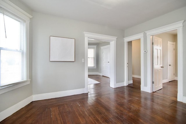 empty room with dark hardwood / wood-style floors