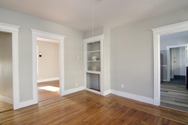 unfurnished room with hardwood / wood-style flooring