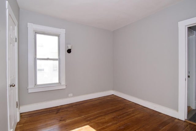 empty room with dark hardwood / wood-style floors