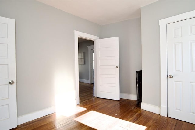 unfurnished bedroom featuring dark wood-type flooring