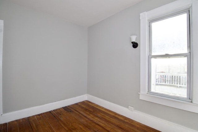 spare room with dark wood-type flooring