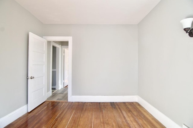 spare room featuring wood-type flooring