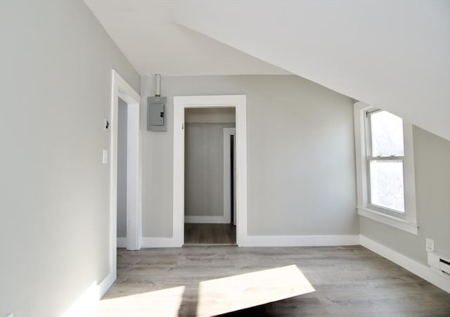 bonus room featuring electric panel and light hardwood / wood-style flooring