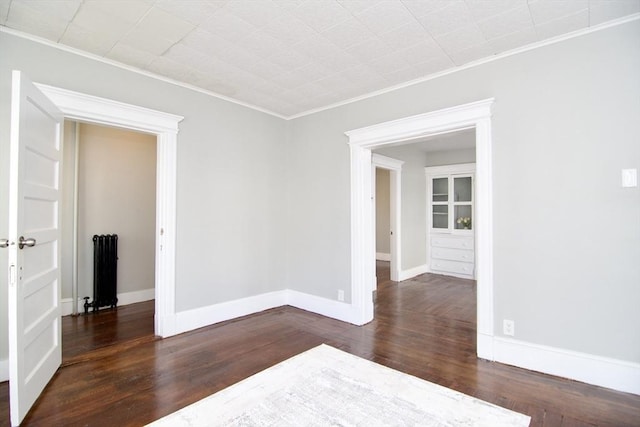 empty room with dark wood-type flooring and ornamental molding