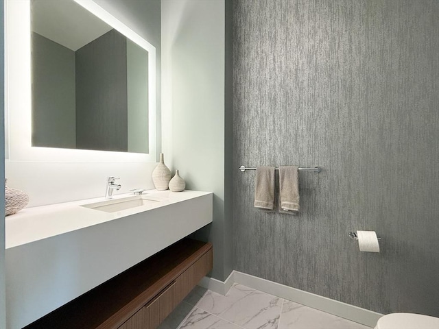 188 Brookline Ave Unit Ph28C, Boston, MA 02215 - bathroom featuring marble look tiles, vanity, toilet, and baseboards