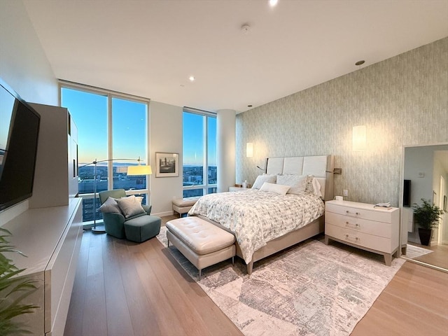 188 Brookline Ave Unit Ph28C, Boston, MA 02215 - bedroom with wallpapered walls, light wood finished floors, floor to ceiling windows, and access to exterior