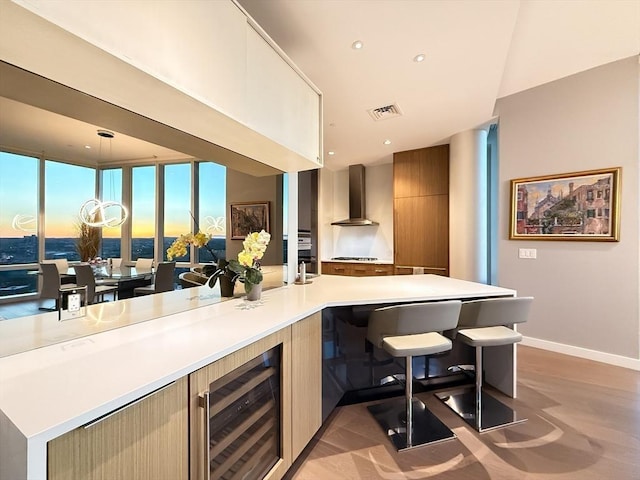 188 Brookline Ave Unit Ph28C, Boston, MA 02215 - bar with wine cooler, wall chimney range hood, baseboards, and recessed lighting