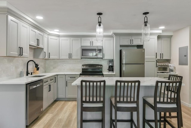 56 Coffey Unit 7, Boston, MA 02122 - kitchen with appliances with stainless steel finishes, electric panel, light wood-style floors, a breakfast bar area, and recessed lighting