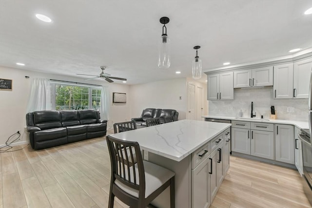 56 Coffey Unit 7, Boston, MA 02122 - kitchen featuring open floor plan, gray cabinetry, light wood-style flooring, ceiling fan, and a center island