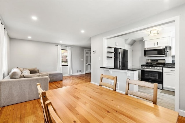 interior space featuring visible vents, recessed lighting, light wood-style floors, and baseboards