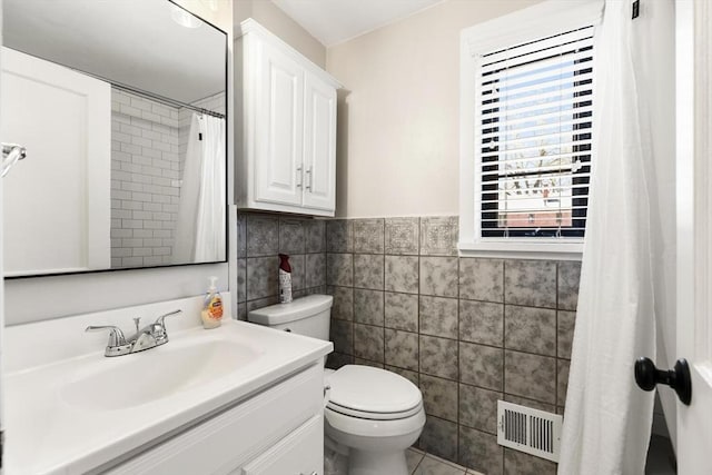 full bath with visible vents, tile walls, tile patterned flooring, vanity, and toilet