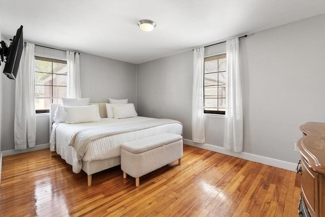 bedroom featuring light wood-style floors and baseboards