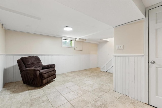 unfurnished room with a wainscoted wall