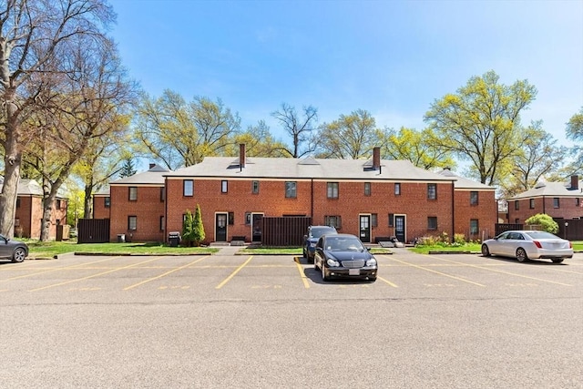 view of building exterior with uncovered parking