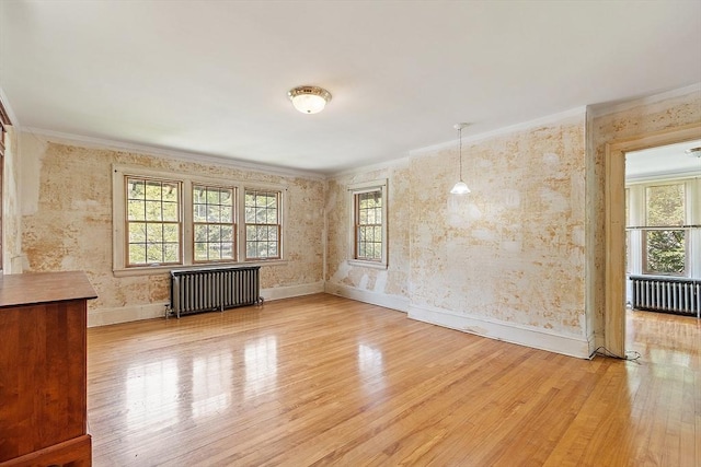 298 Highland St, Worcester, MA 01602 - unfurnished room with radiator heating unit, ornamental molding, wood finished floors, baseboards, and wallpapered walls