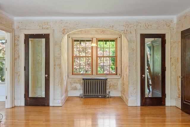 298 Highland St, Worcester, MA 01602 - entryway with radiator heating unit, wood finished floors, healthy amount of natural light, and wallpapered walls