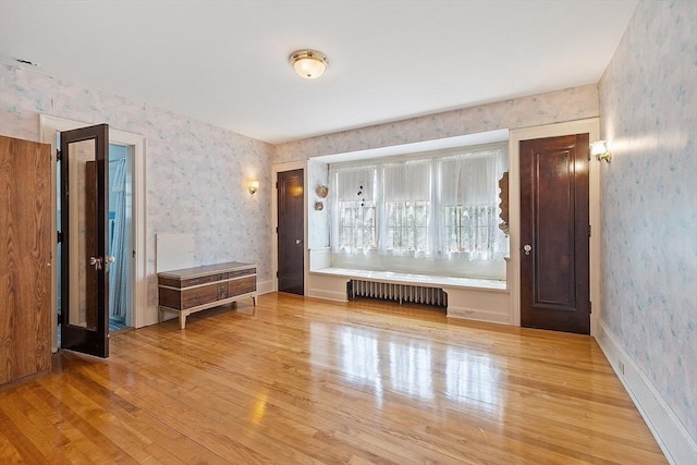 298 Highland St, Worcester, MA 01602 - unfurnished room featuring wallpapered walls, radiator, and wood finished floors